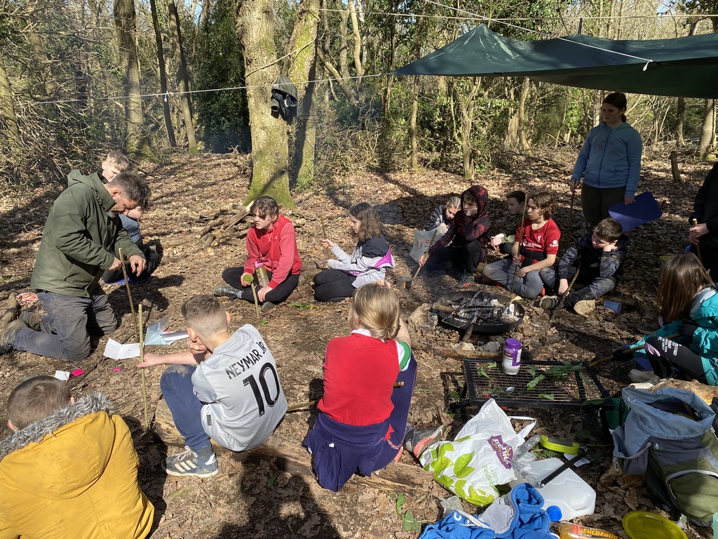 young people and youth workers at Abergele Youth Den during forest school learning how to use knives safely